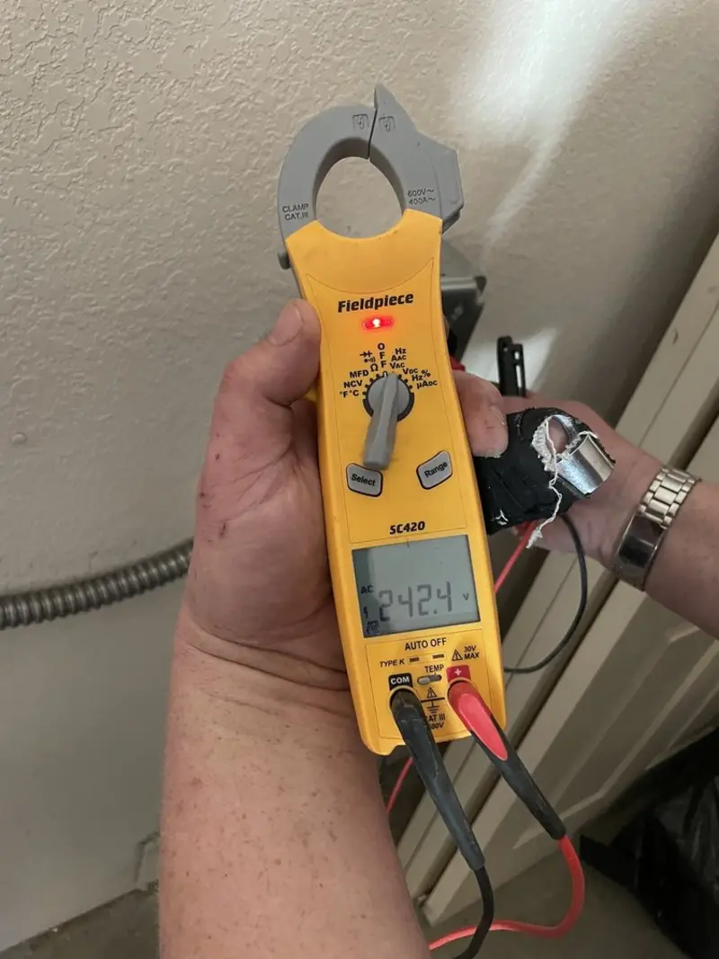 Voltage testing with clamp meter during Ceiling Fan Installation in Swanton